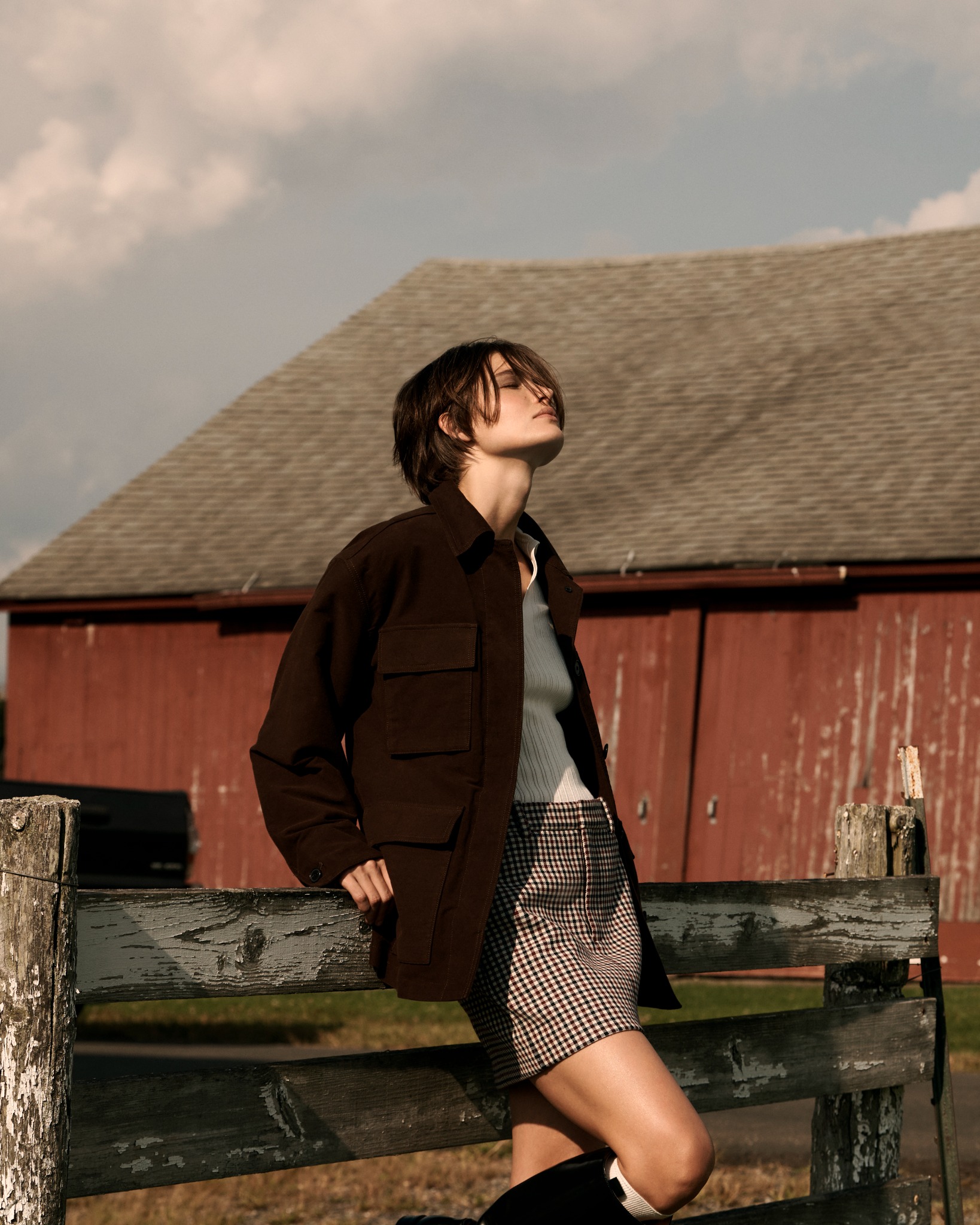 Woman by red barn